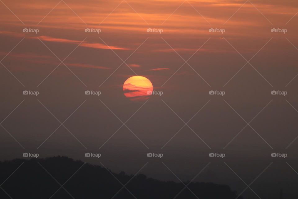 Early morning sun on the cloudy sky. At dawn view from high ground