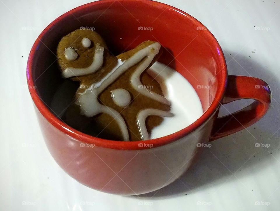 funny ginger man cookies in cup milk
