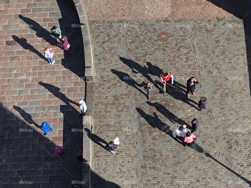 
Looking for shadows -  Shadows of people cast on the street from above - Shadows help define the shape of objects in an image, conveying the sense that you're looking at something that's three-dimensional