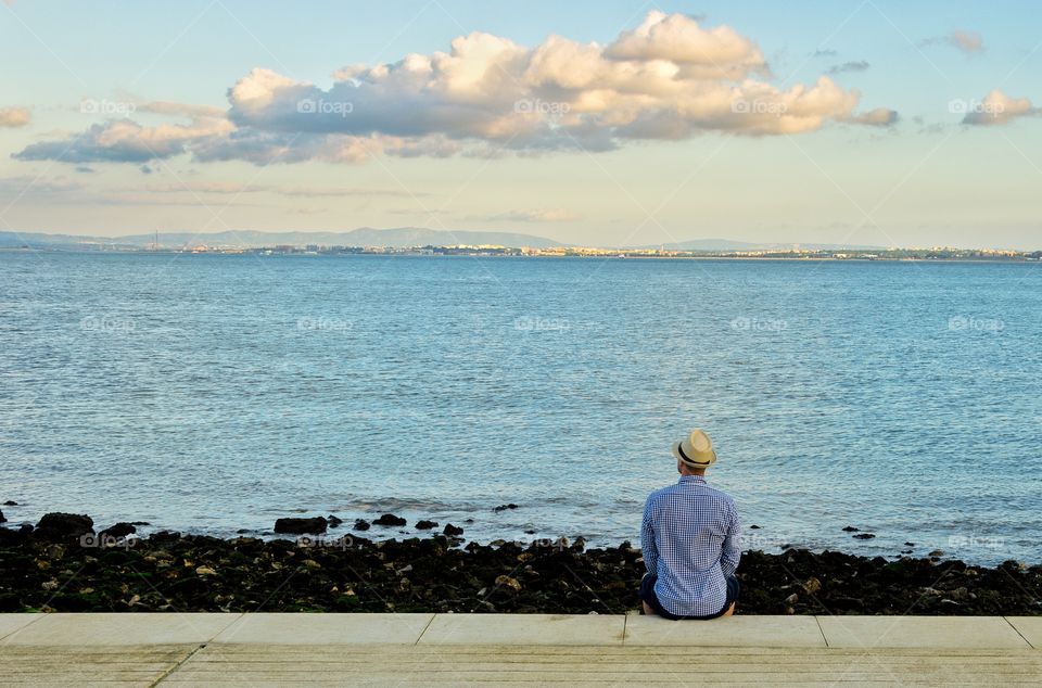 Rear view of man looking at sea