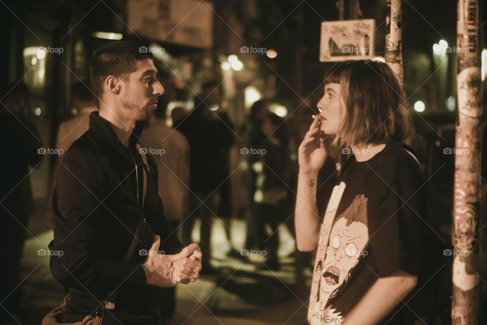 Talking to my friend. Talking night outside a trashy bar in Willamsburg, NYC