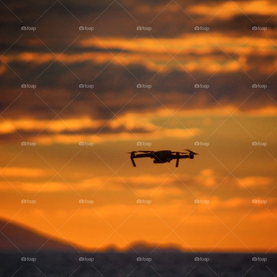 Silhouette of drone at sunset
