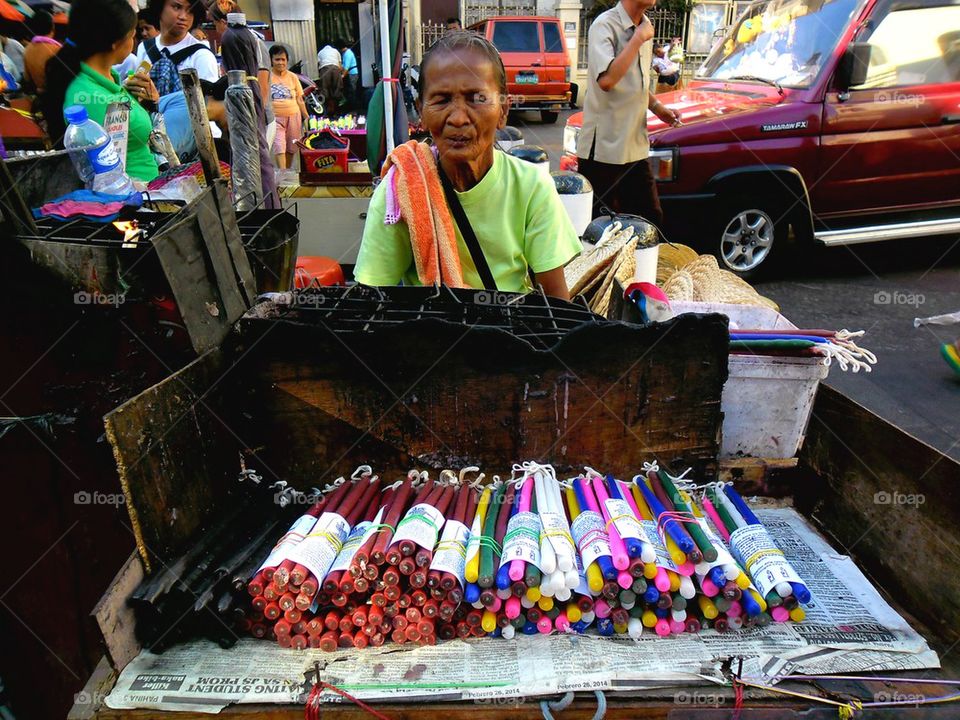 street vendor selling colored candles