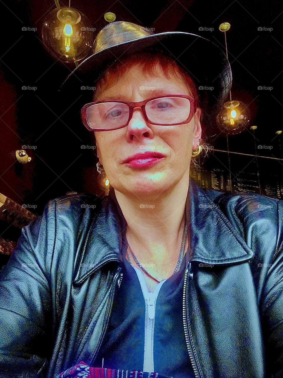 Portrait photograph from somewhere in the vicinity of Brooklyn in an outdoor café wearing a cool leather jacket. 2019. Hypnotic Productions