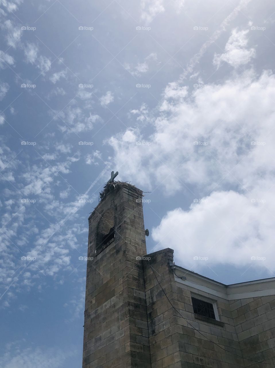 Osprey nest atop brick church steeple tower 