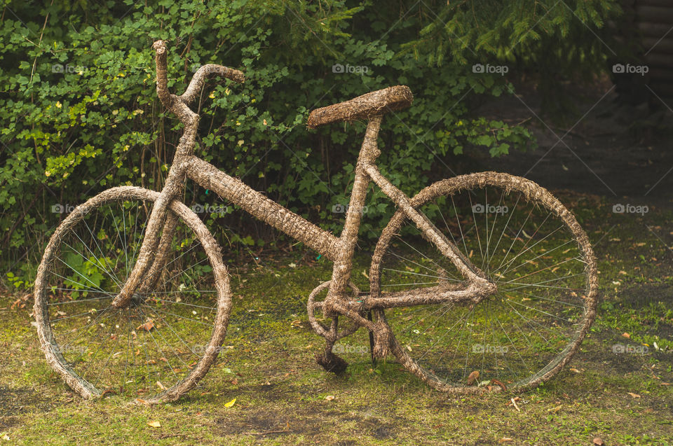 Creative installation with bicycle and green grass 