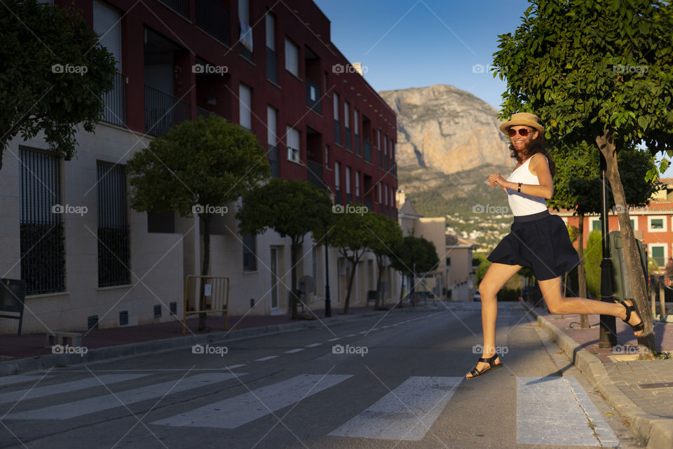 Girl runs across the road