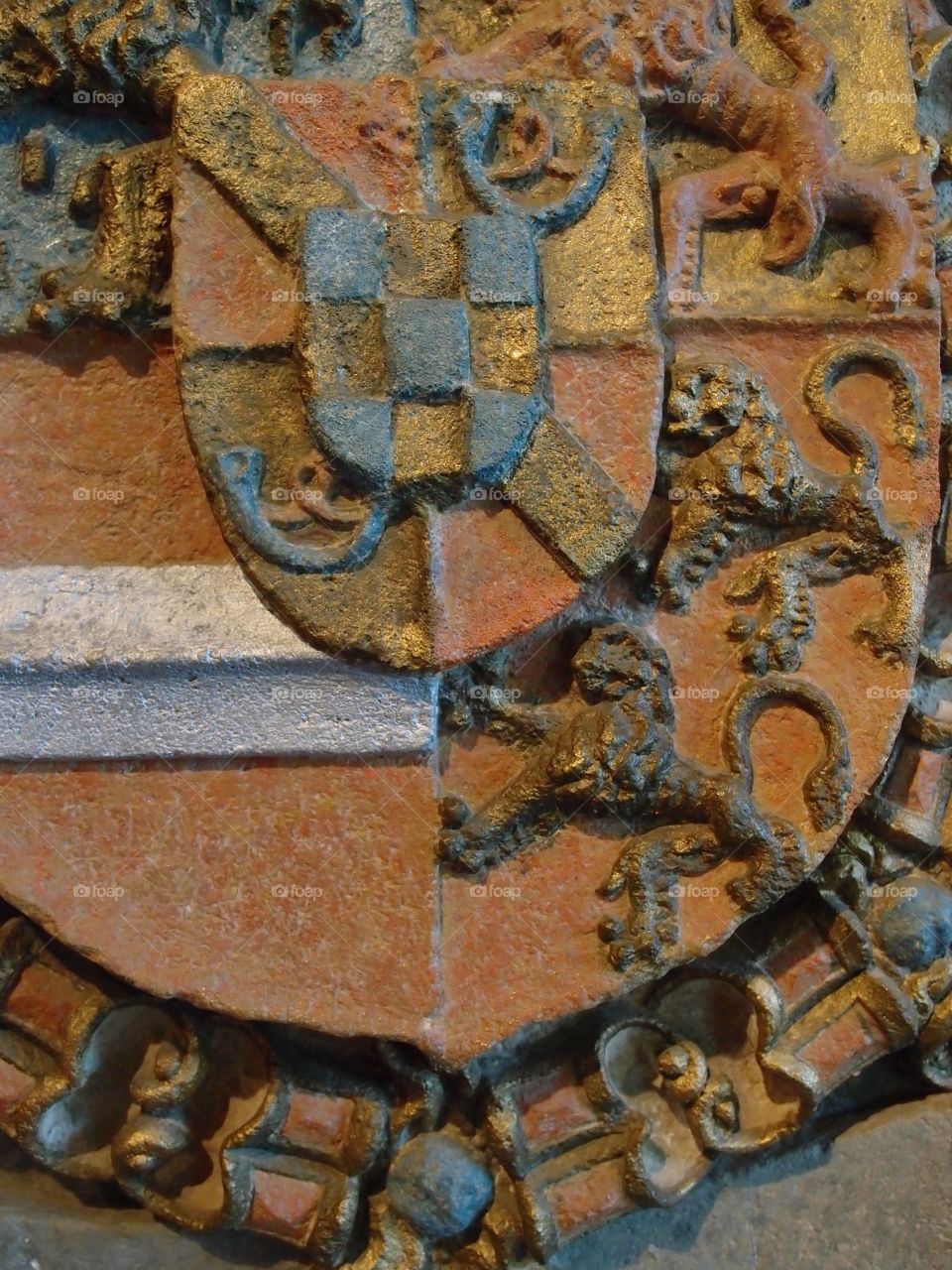 A decorative family crest with decorative lions and a patterned shield in the Chateau dé Vianden in Northern Luxembourg. 