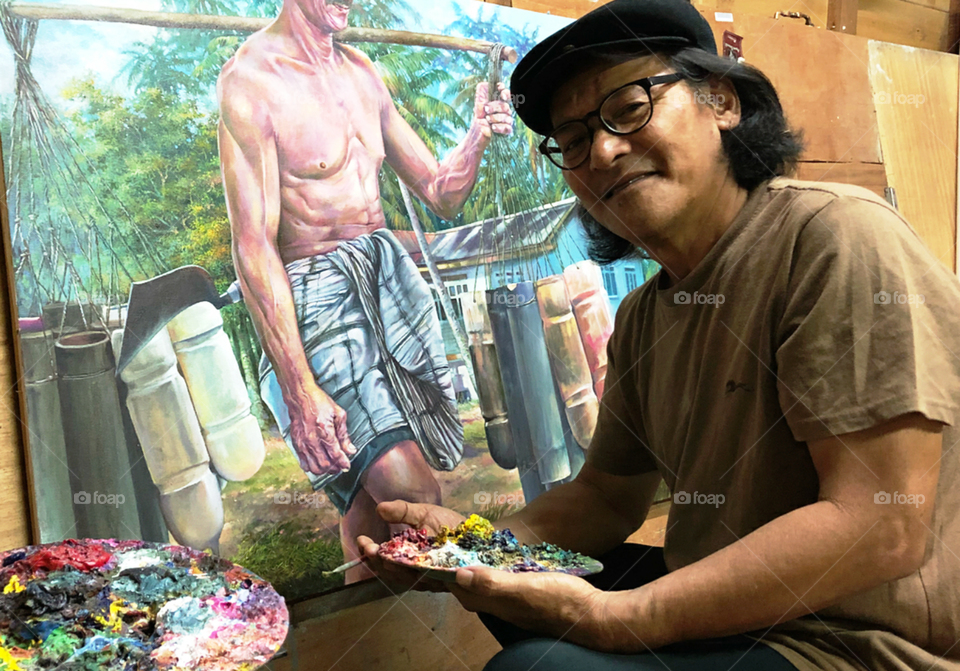 a unique hobby. Mr Nazli Hamzah the realist painter in his studio.