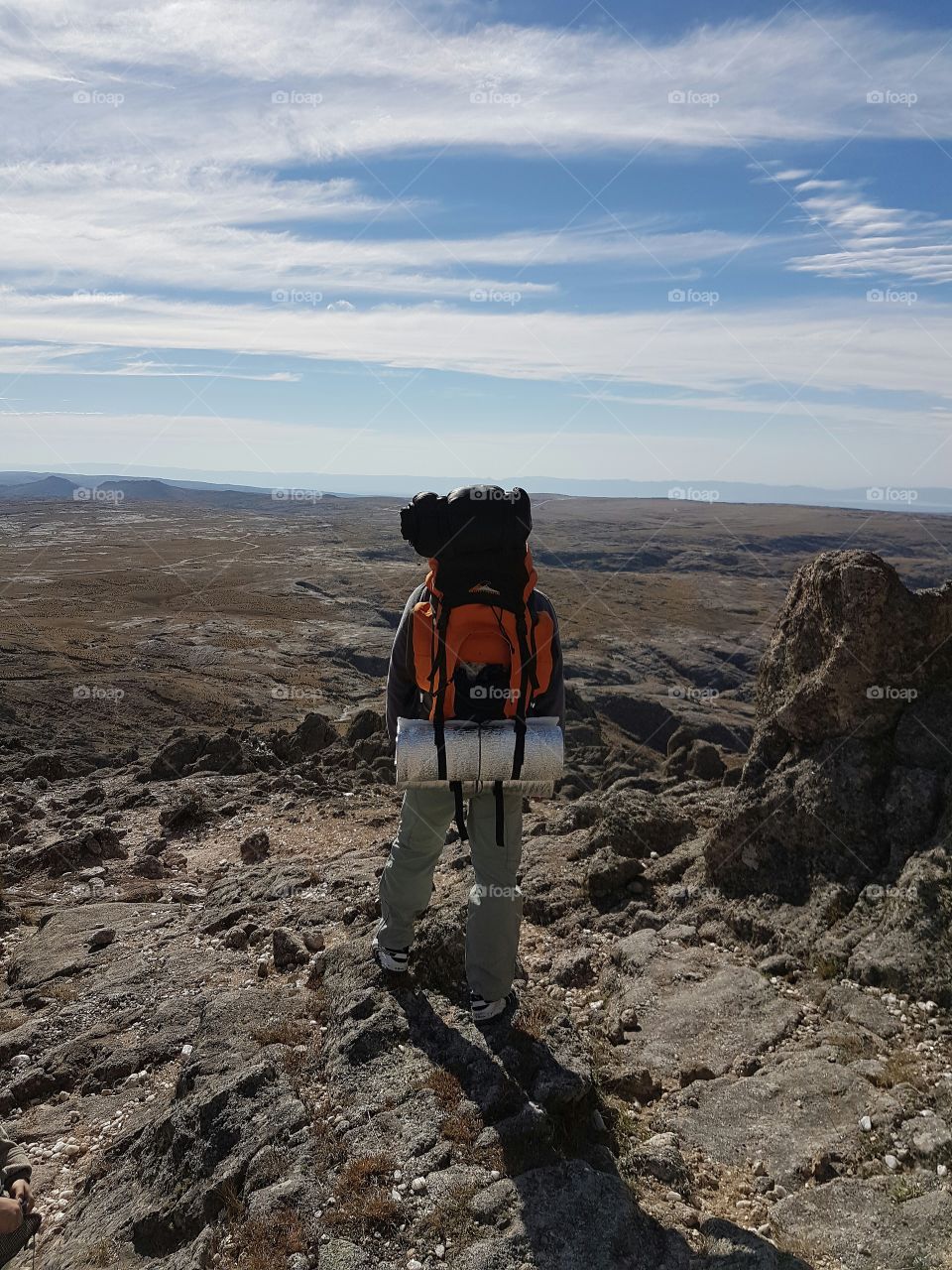 Man hiking mountains with Backpack on his shoulders