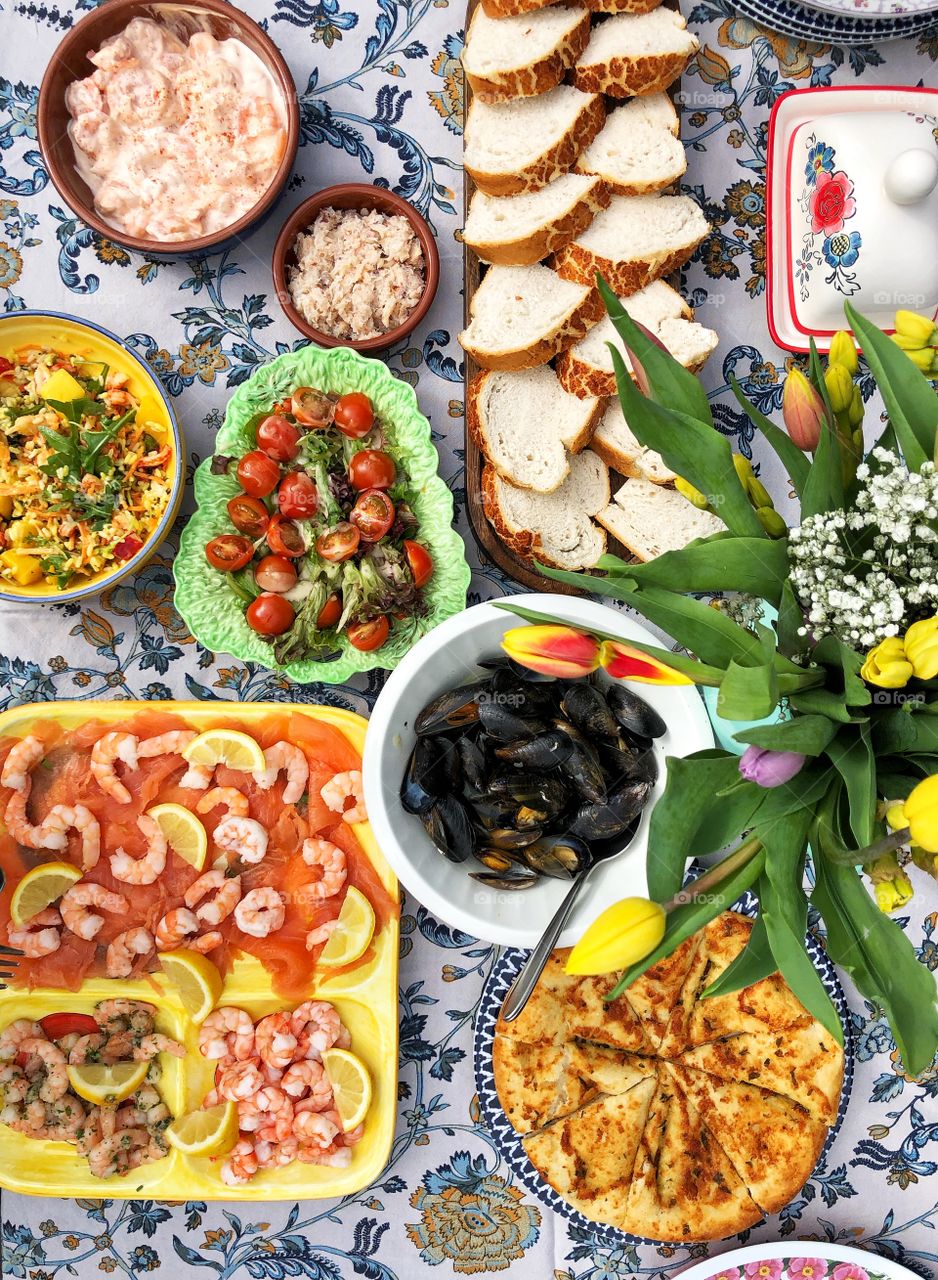 Flat lay of delicious seafood and healthy eating salads and fruit in an outdoor buffet table top