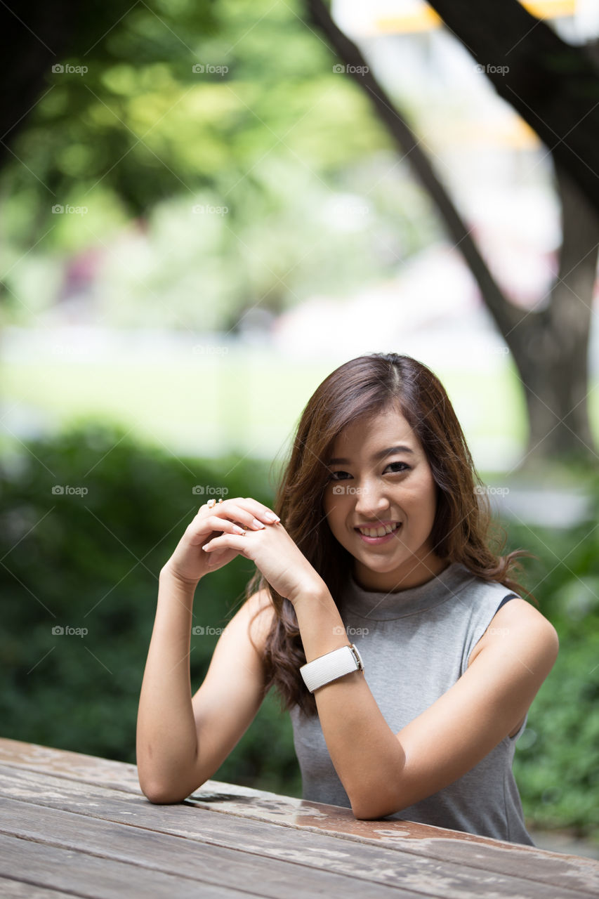 Asian girl sitting on the table 