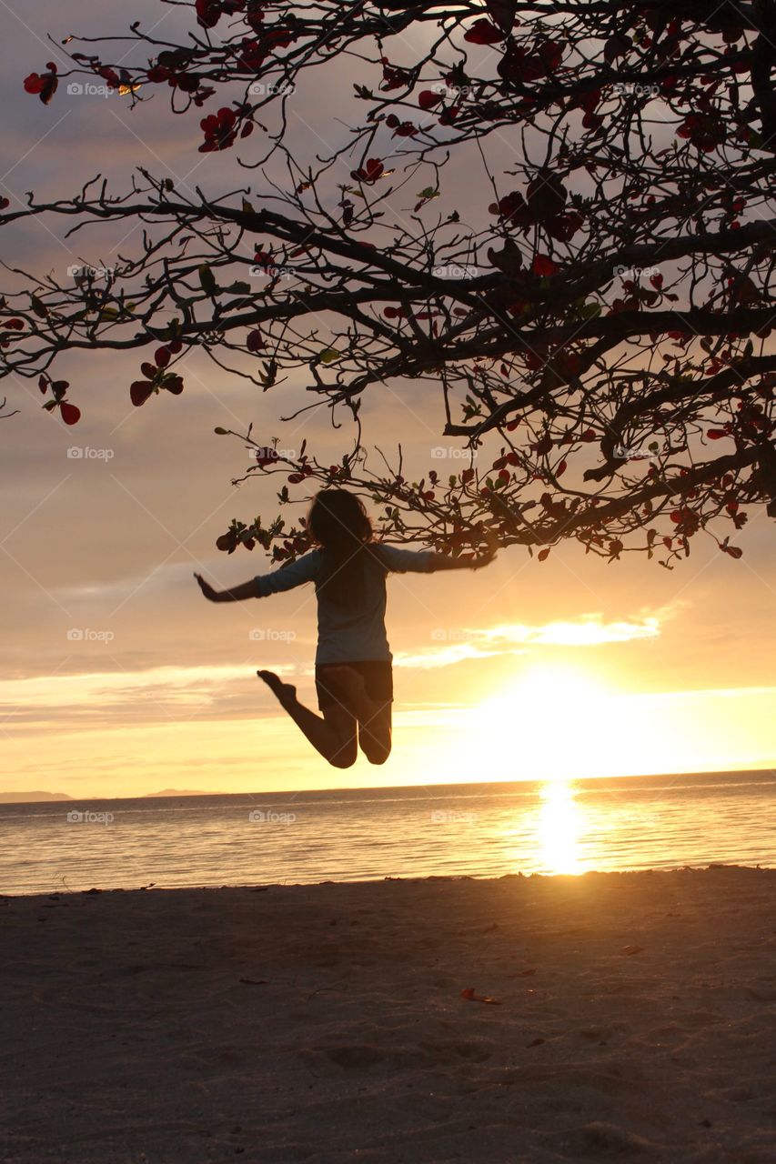 Woman jumping in the beach