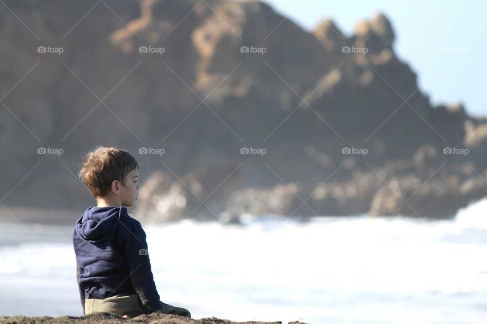 Boy looking out at the ocean