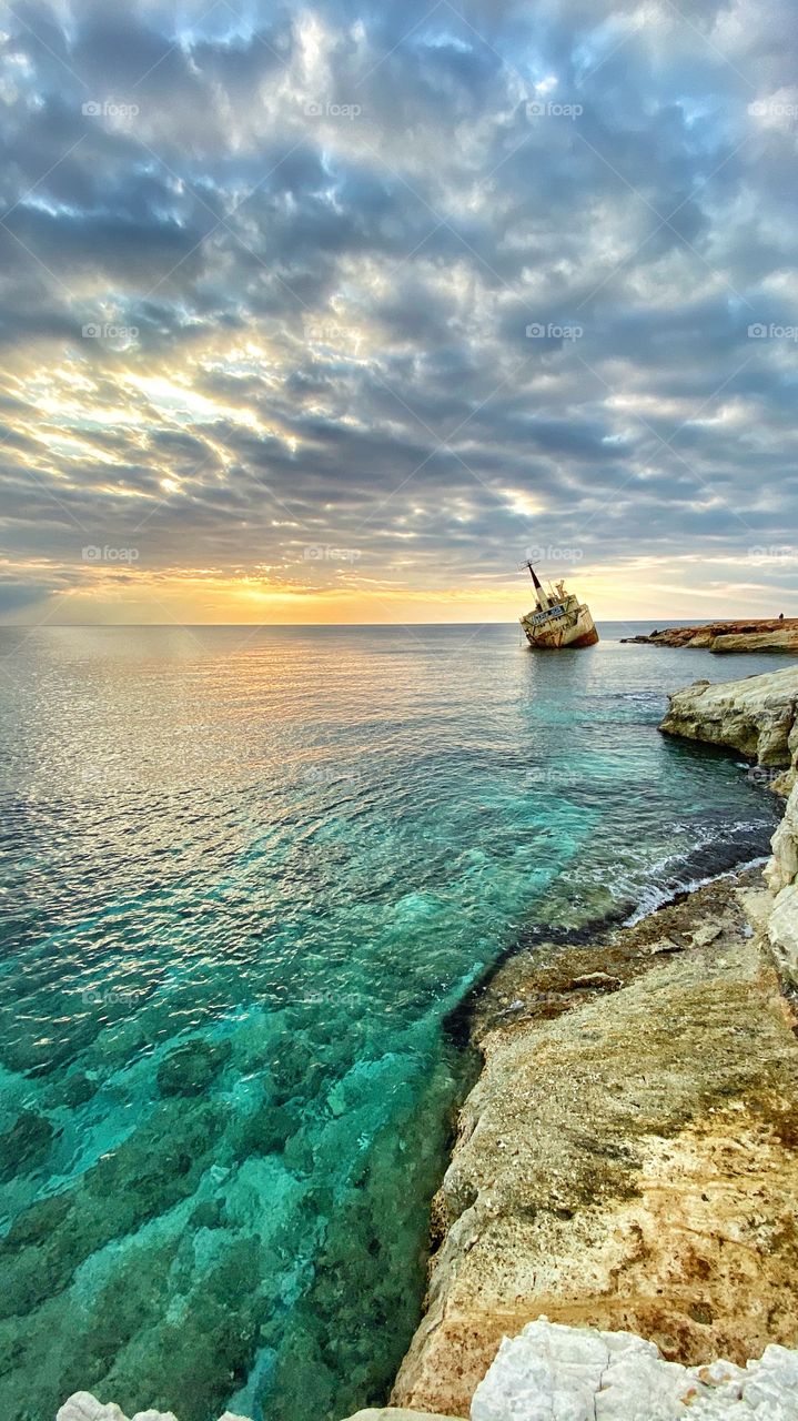 A ship stack in rocks after a huge storm some 10-12 years ago. Since then , this shipwreck has been a place of interest and a photography spot for locals and tourists. This is in Paphos, Cyprus.