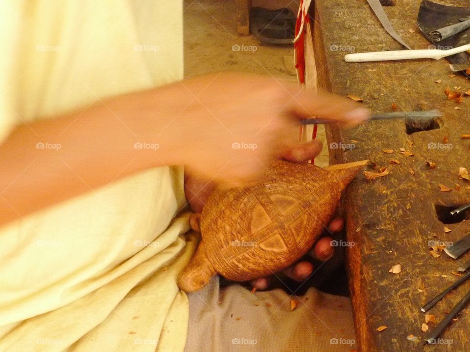Making a wooden sculpture of a turtle in Cambodia 