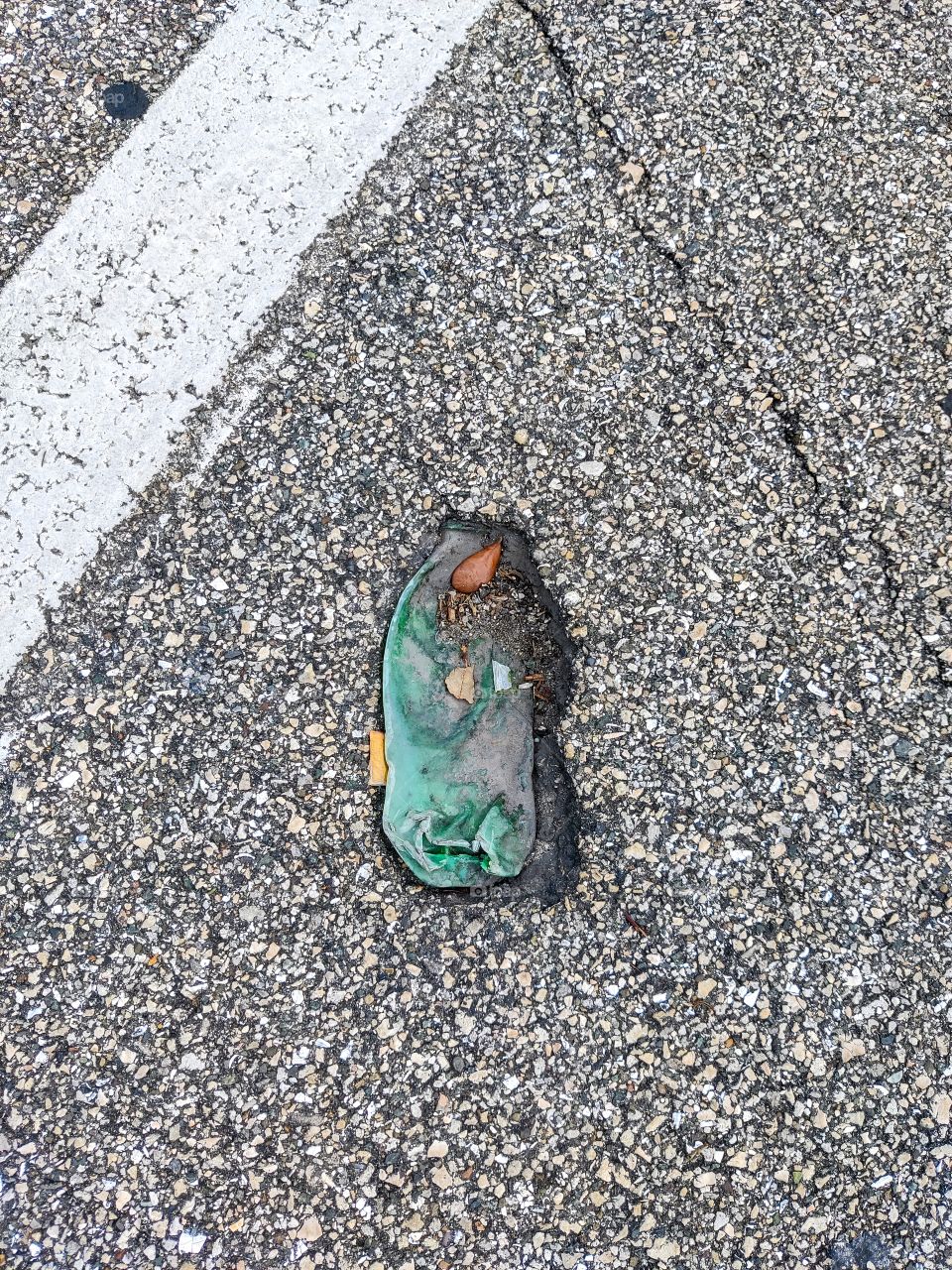 bottle in asphalt