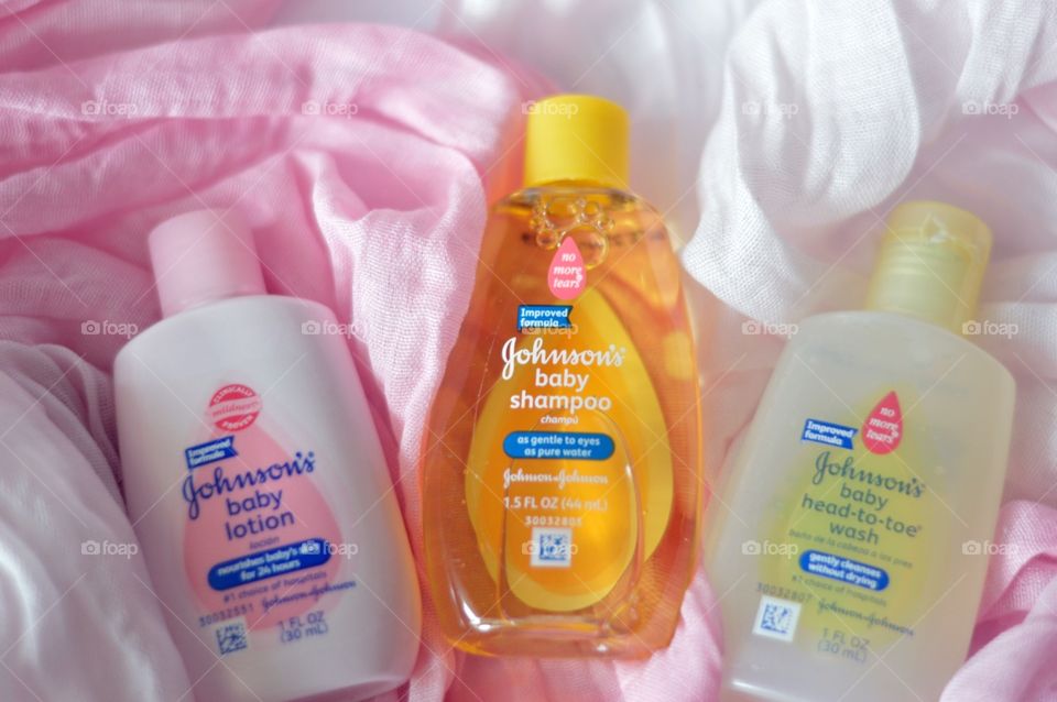 Johnson and Johnson baby products on a pink background flat lay 