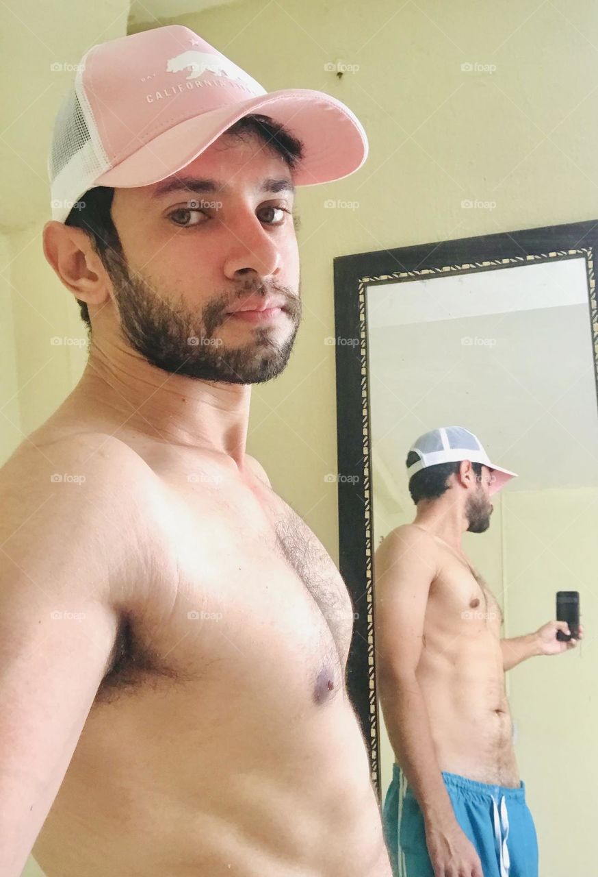 Handsome boy taking selfie photo in the mirror