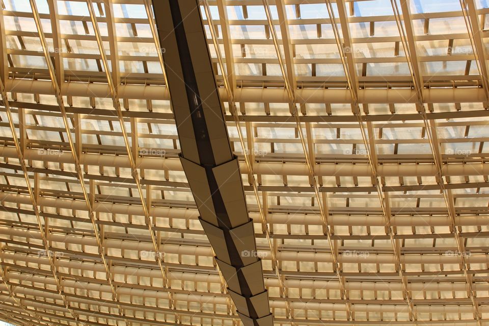 Structural design of the yellow roof of a open air shopping center in Paris.