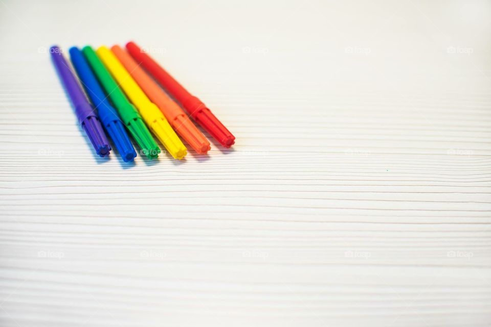 Multicolored Markers On A Wooden Background