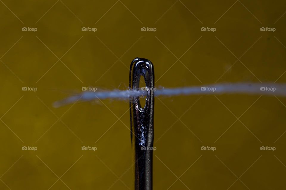 Macro shot of needle and thread.