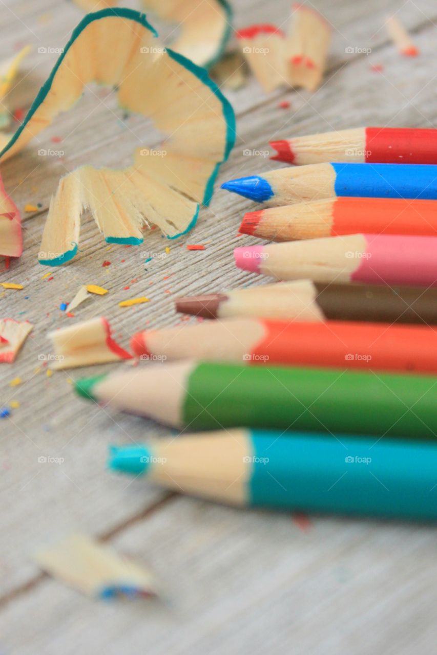 Multi colored pencils on wood