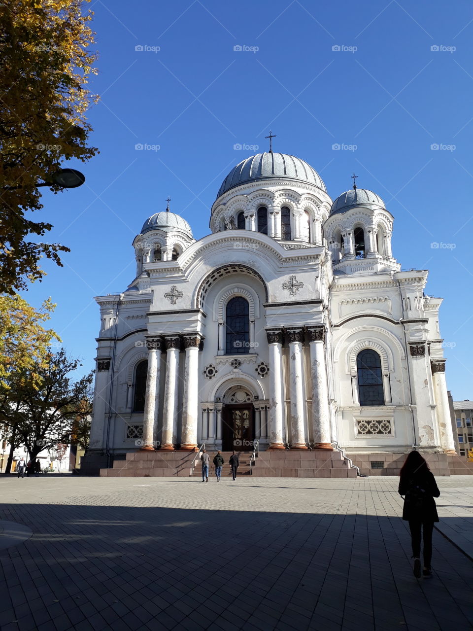 Church in Kaunas - three towers, three people, three stairs, three columns