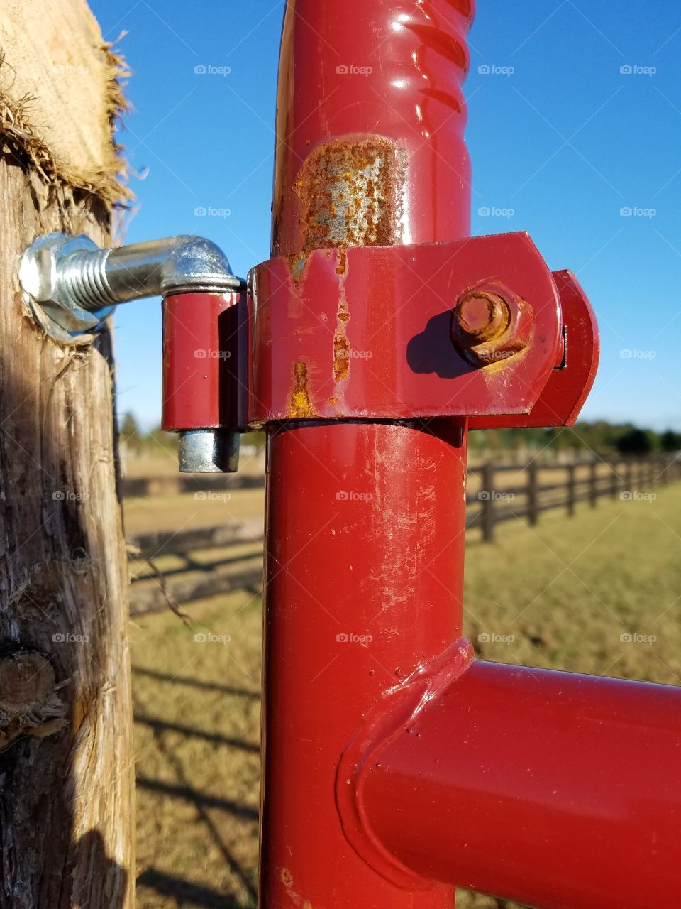 Random photo of a gate attached to a wooden post.