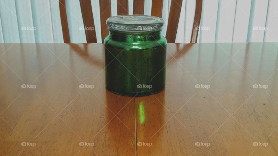 Green glow from sunlight shining through a jar, Backlot by light through aqua window shades