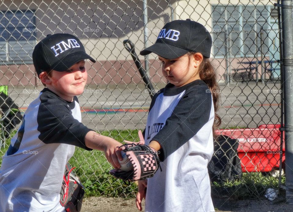 Young Boy And Girl In Baseball Uniforms