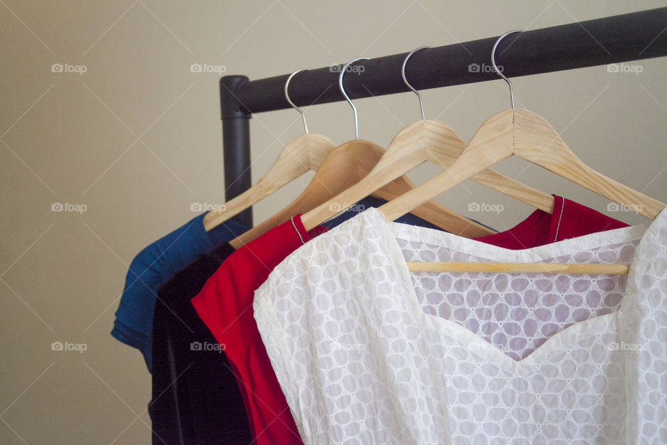 Close up of bright dresses on a rack