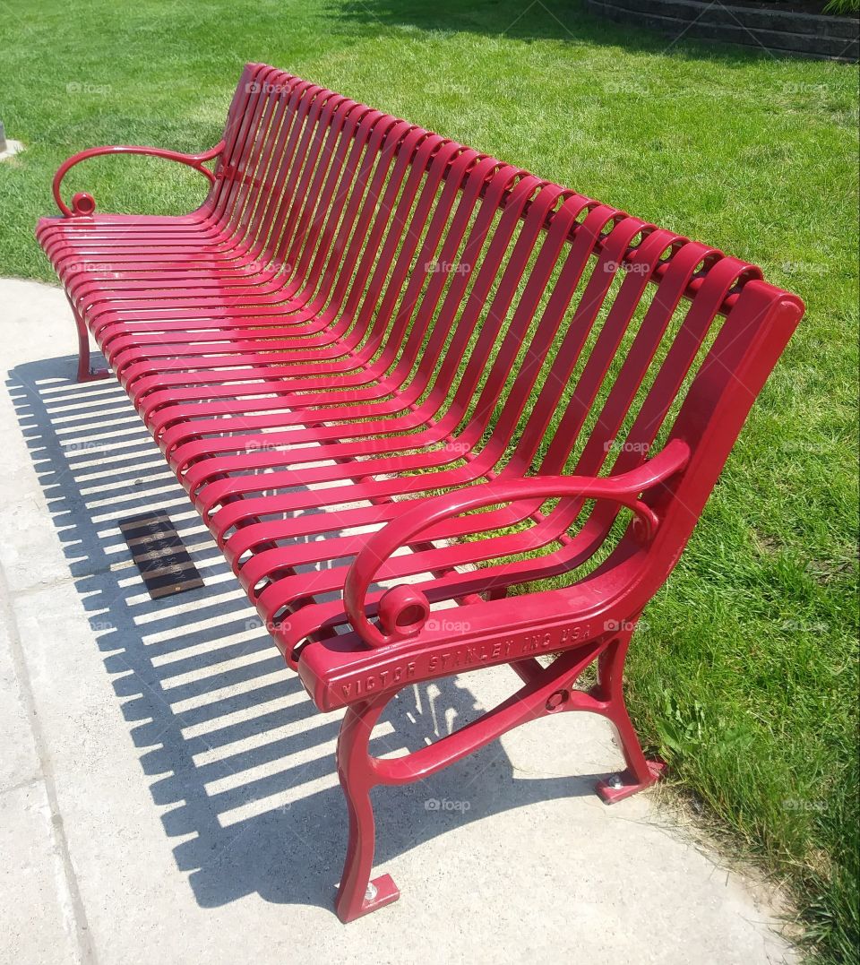 Curved red metal bench