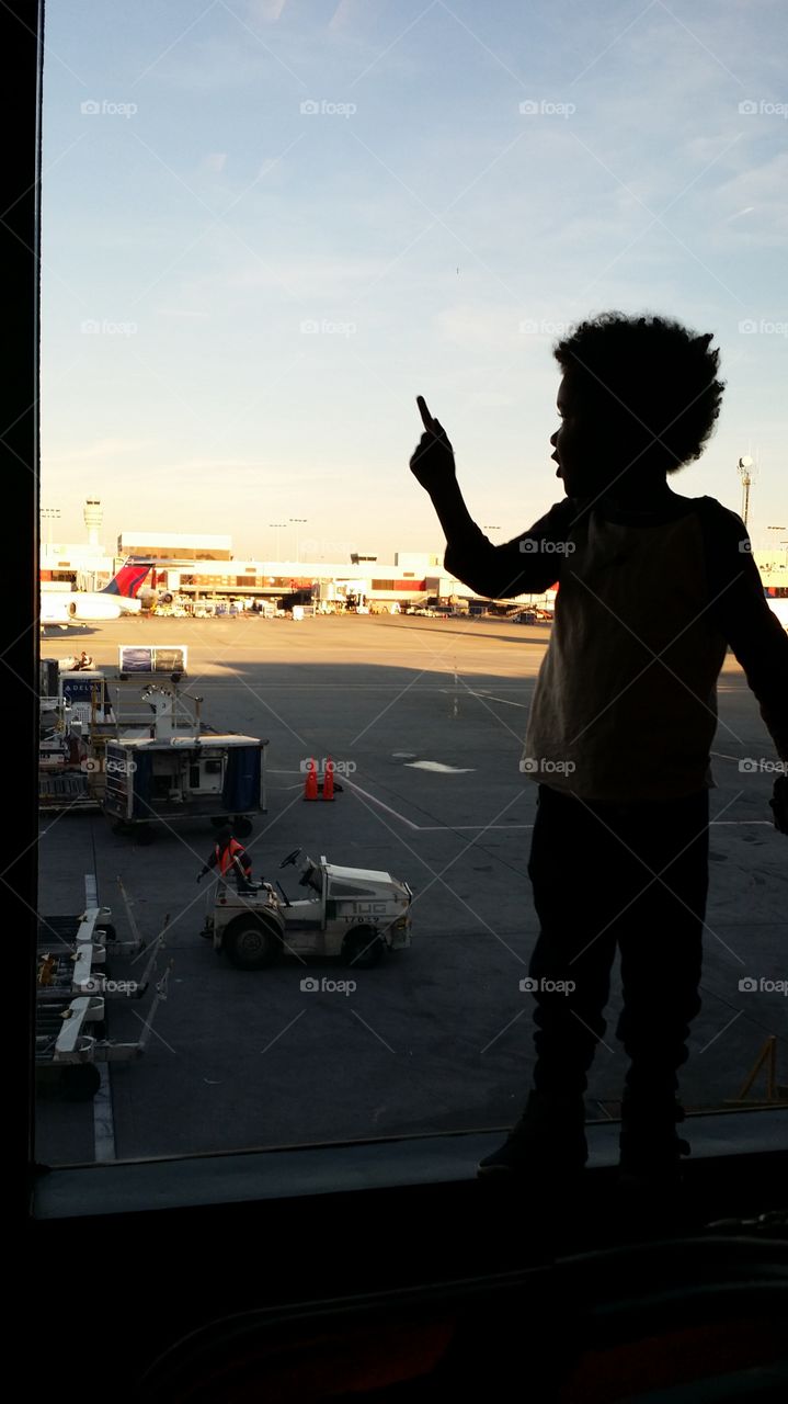Watching airplanes. Young boy at Atlanta airport