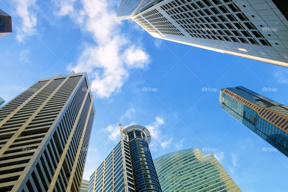 Bottom view of buildings, Blue sky background.