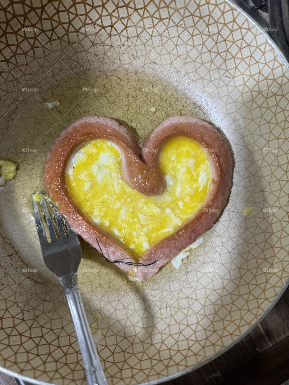 Sausage and eggs cooked in the shape of a heart