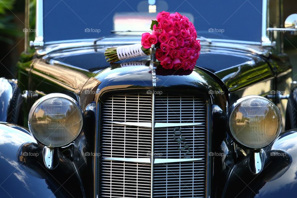 Auburn limo with flowers om top