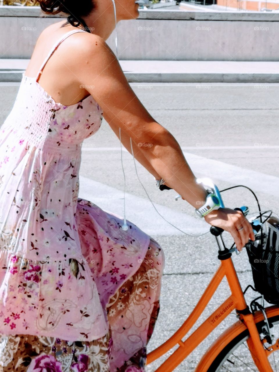 Detail of a woman on a bicycle.