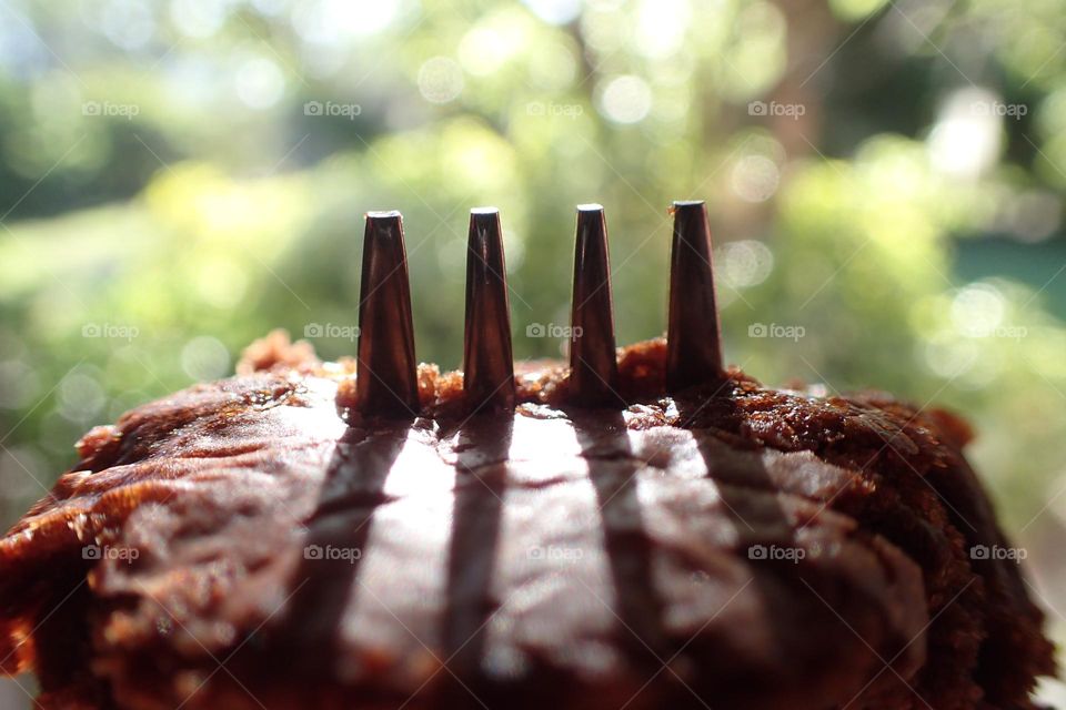 Tips of fork sticking up through delicious brownie