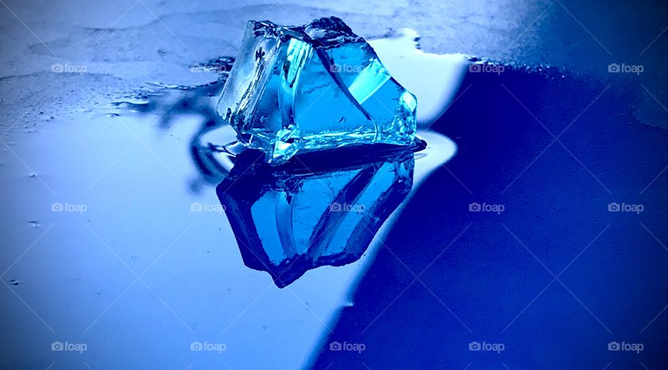 Blue crystal reflecting in the puddle