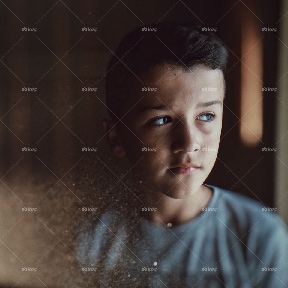 Boy looking through window