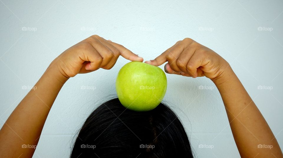 Green apple On girl's head