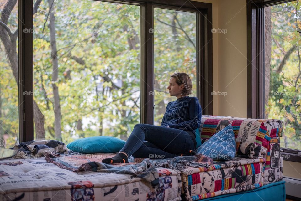 Woman relaxing in front of a window