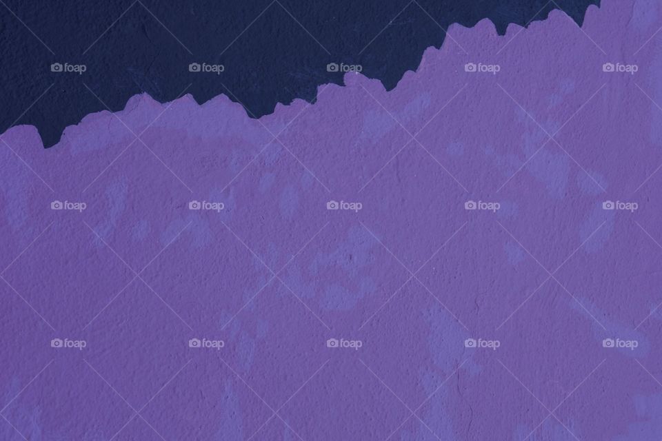 Purple and dark blue colors on an exterior concrete wall represents the  early beginnings of    a team of artists creating a mural in San Miguel de Allende, Mexico
