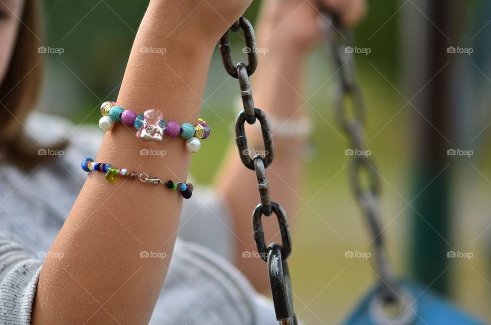 A young girl on the swings at the playground