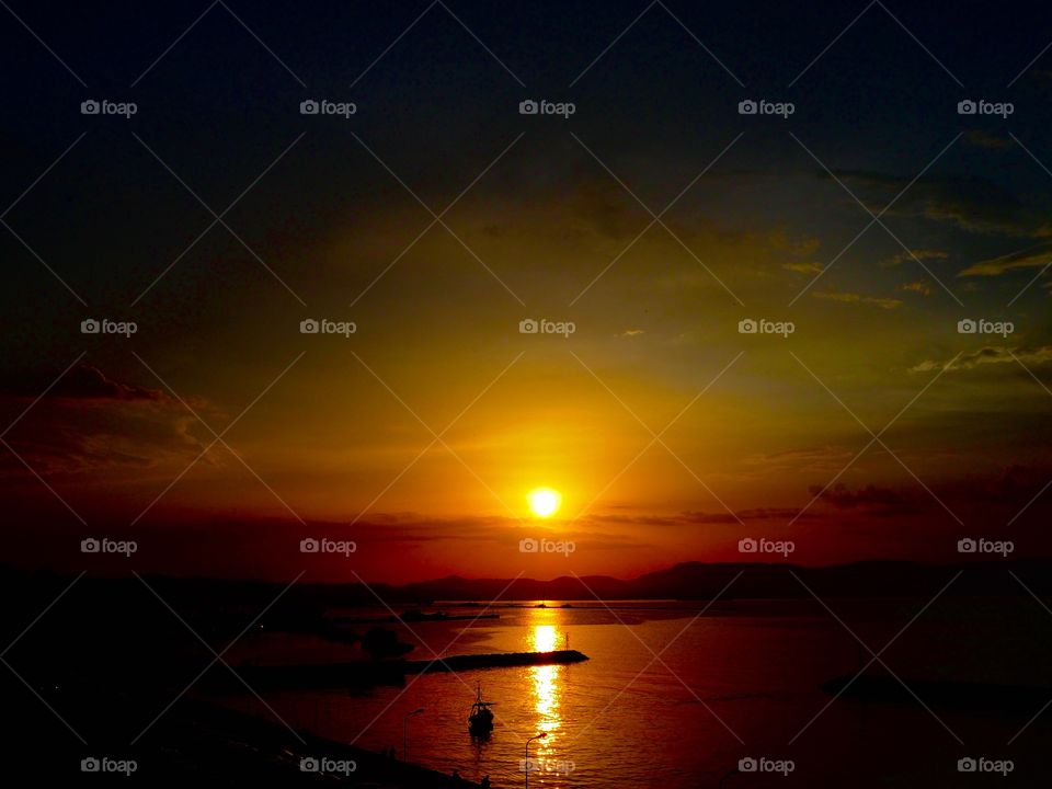 Deep sunset over Corfu Town Old Harbour, Greece