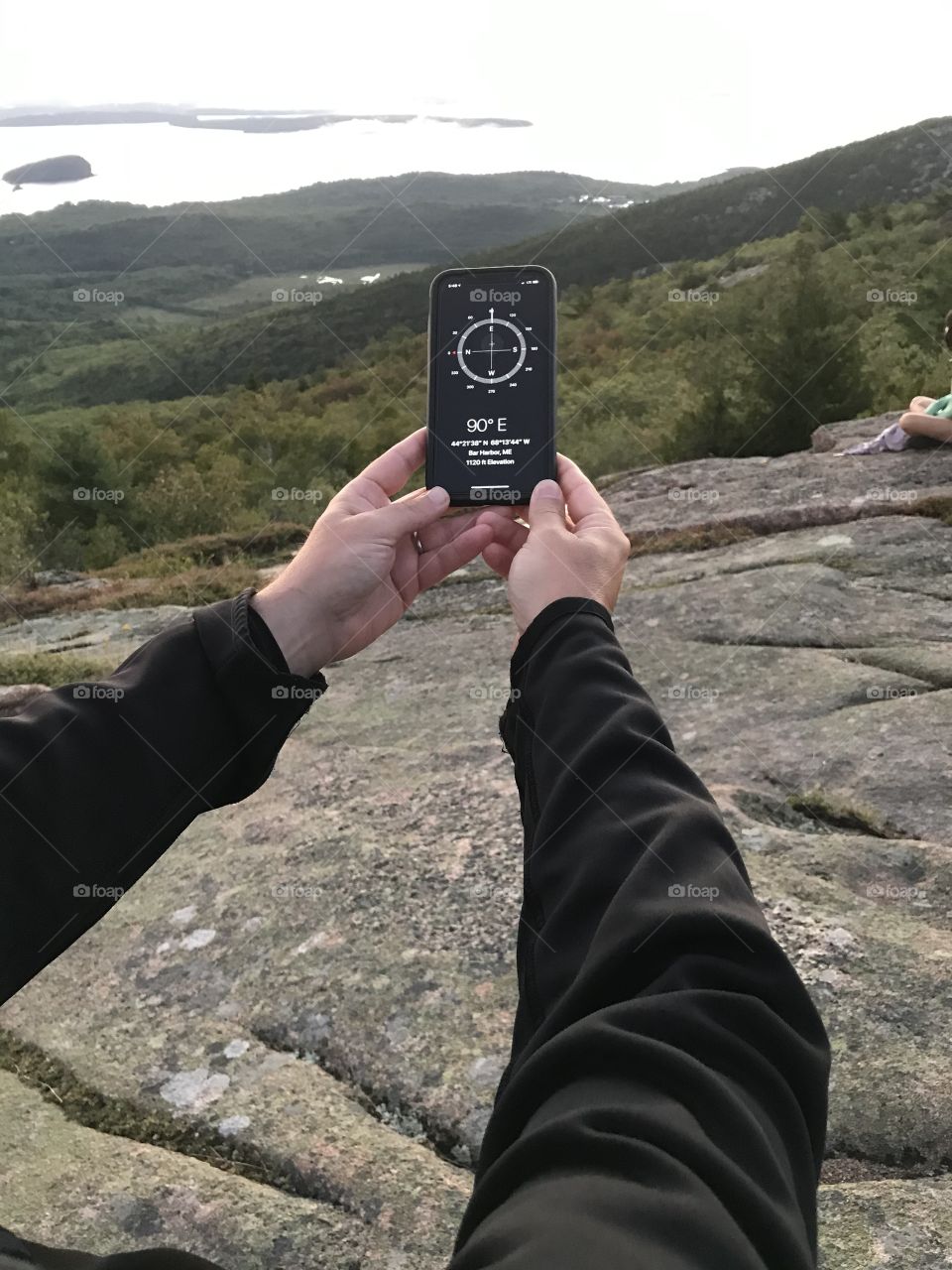 Navigating with a compass on a cloudy mountain hike