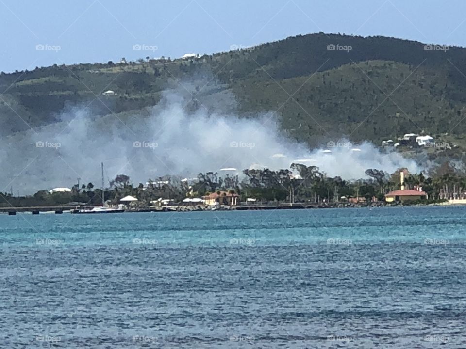 Fire burning over buildings at beach