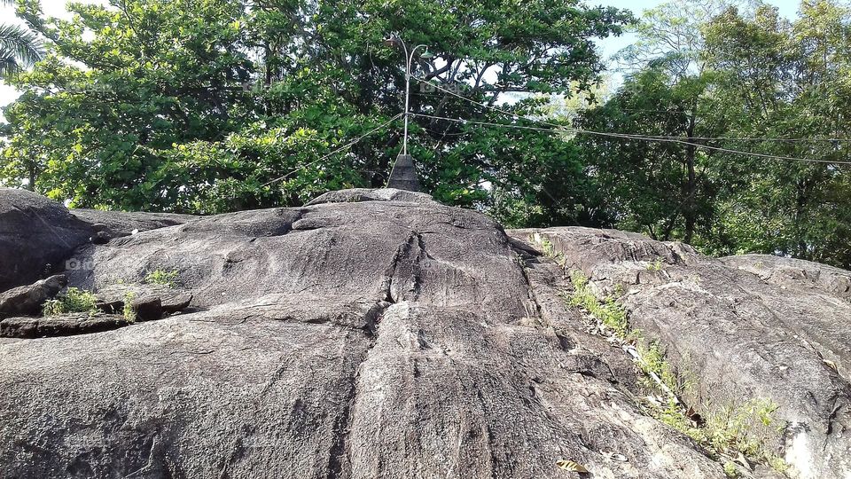 Rock hill with a flat pattern, installed lighting equipment on it.