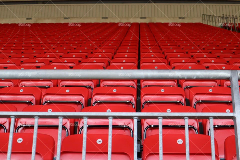 Red chairs in Anfiled football stadium Liverpool 
